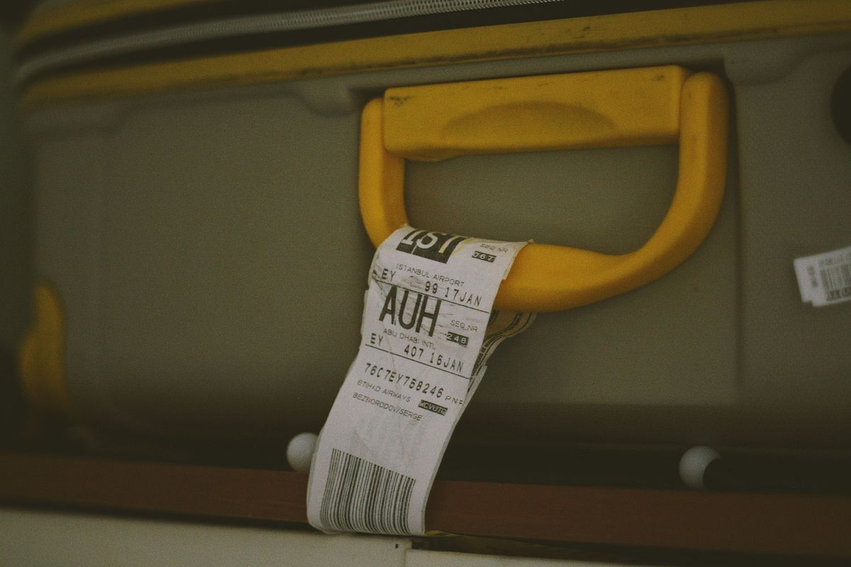 Airline baggage tag on a suitcase handle