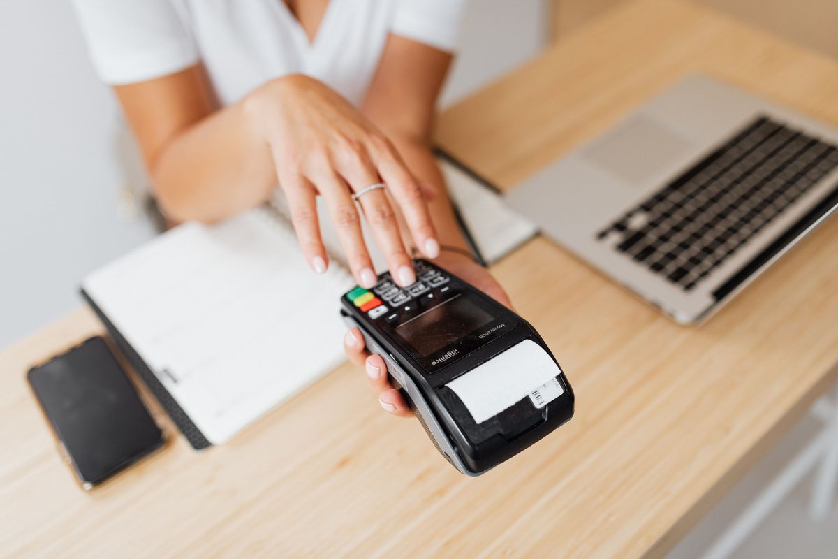 Card machine printing a receipt at a counter