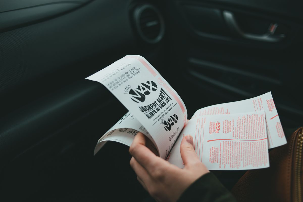 Hands holding printed tickets